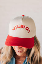 Blonde woman wearing a hat with LOS ANGELES embroidered upside down on a Vintage Two Tone Trucker Hat.