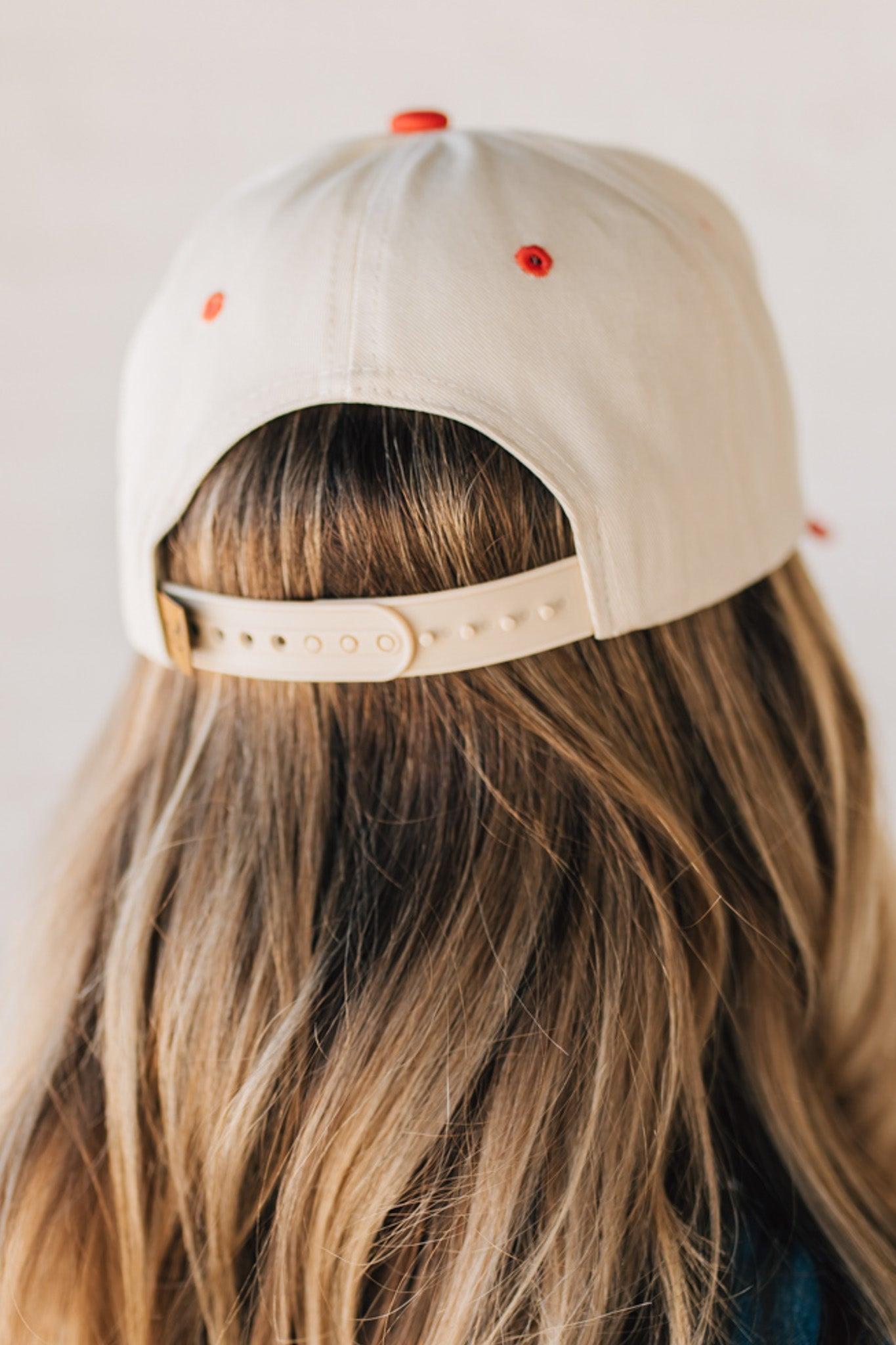 Blonde woman wearing a hat with LOS ANGELES embroidered upside down on a Vintage Two Tone Trucker Hat.