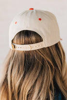Blonde woman wearing a hat with LOS ANGELES embroidered upside down on a Vintage Two Tone Trucker Hat.