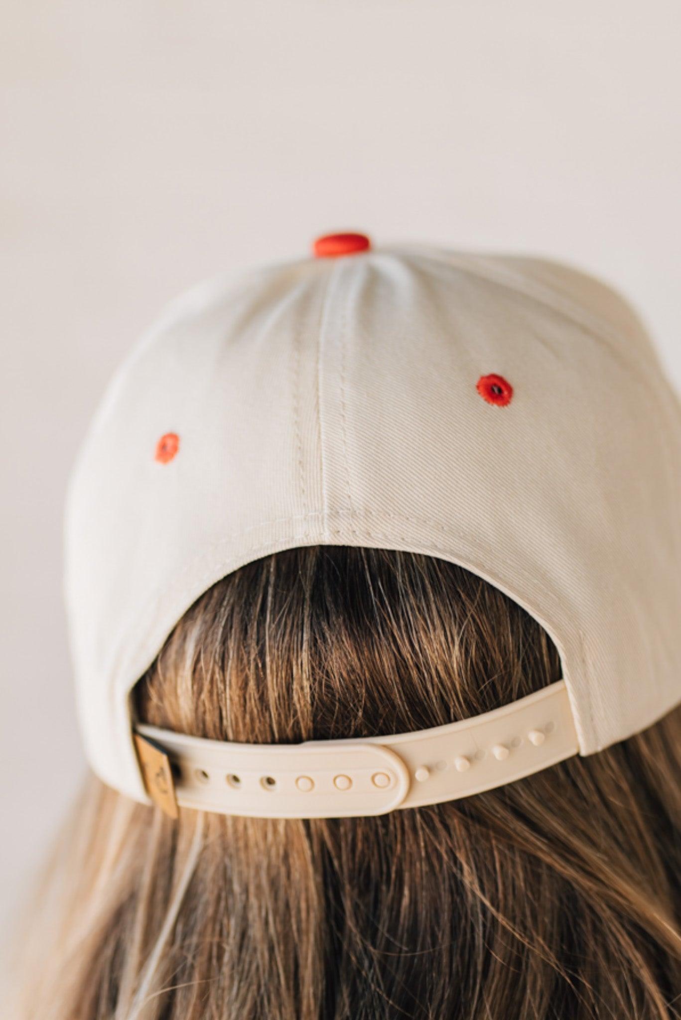 Blonde woman wearing a hat with LOS ANGELES embroidered upside down on a Vintage Two Tone Trucker Hat.