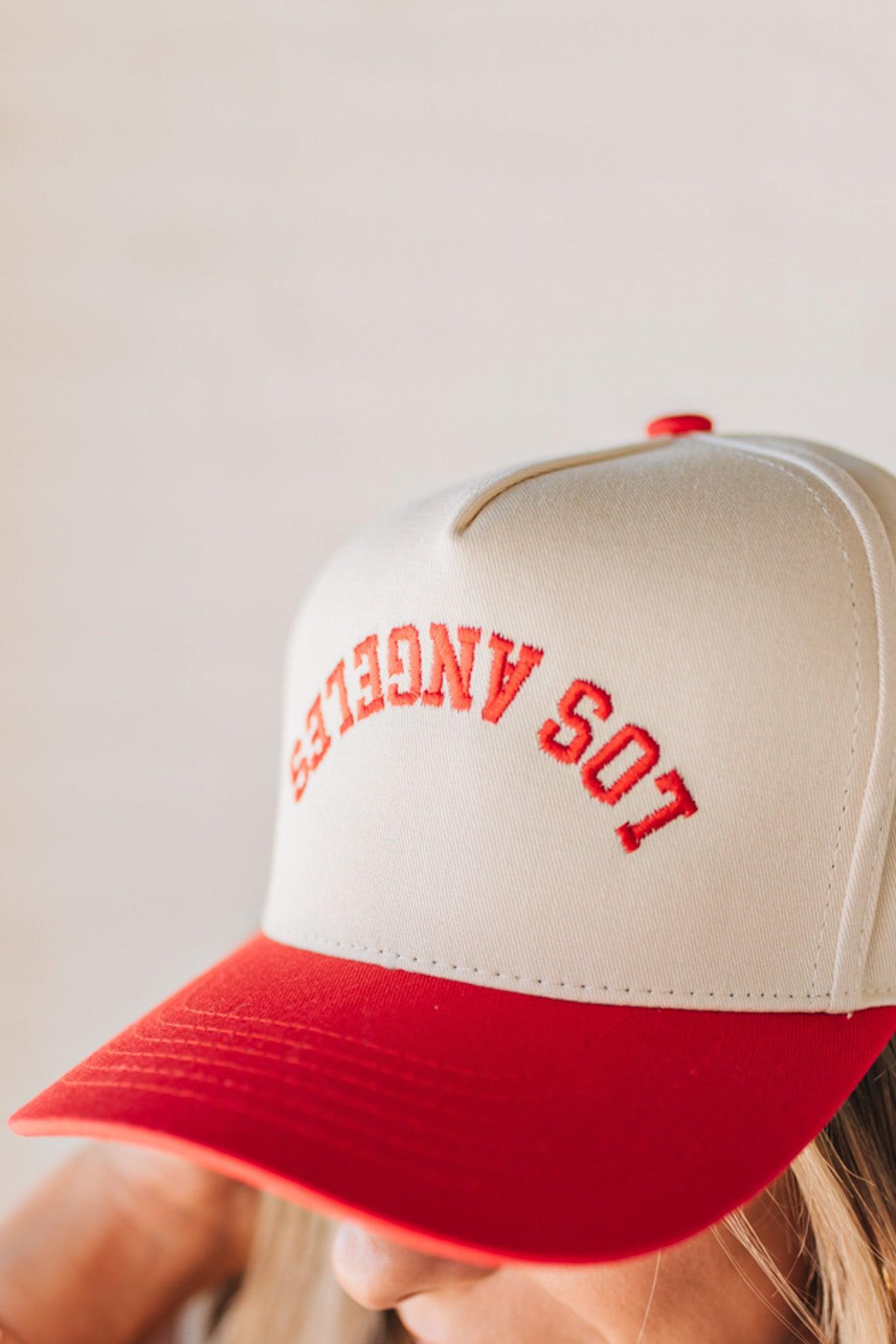 Blonde woman wearing a hat with LOS ANGELES embroidered upside down on a Vintage Two Tone Trucker Hat.