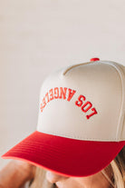 Blonde woman wearing a hat with LOS ANGELES embroidered upside down on a Vintage Two Tone Trucker Hat.
