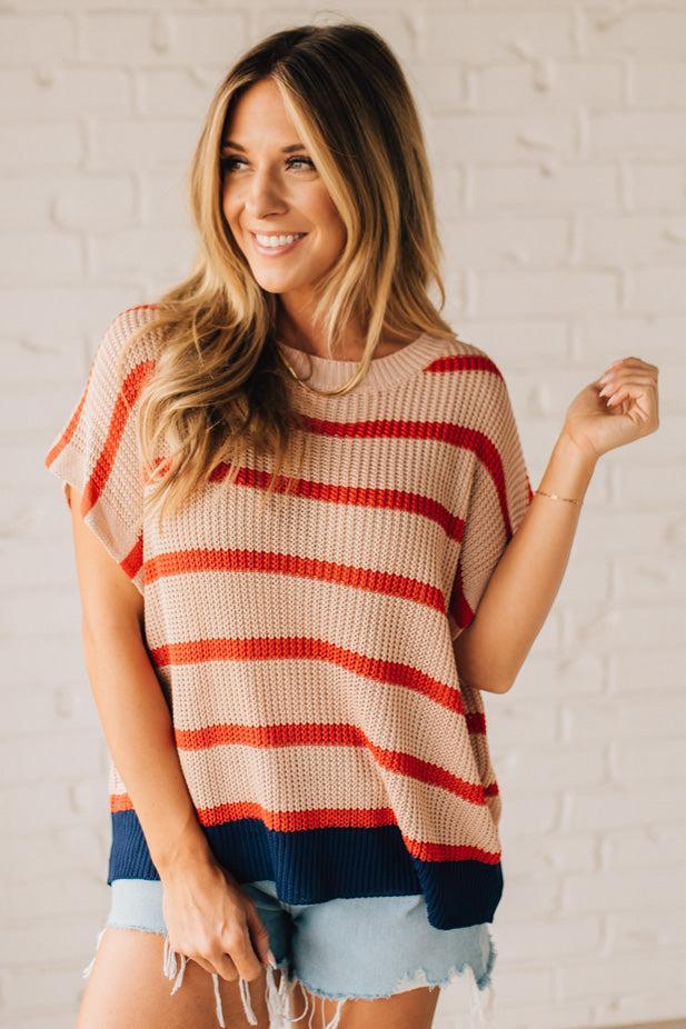 Blonde woman wearing a beige, red, and navy Stripe Drop Shoulder Sweater Top.