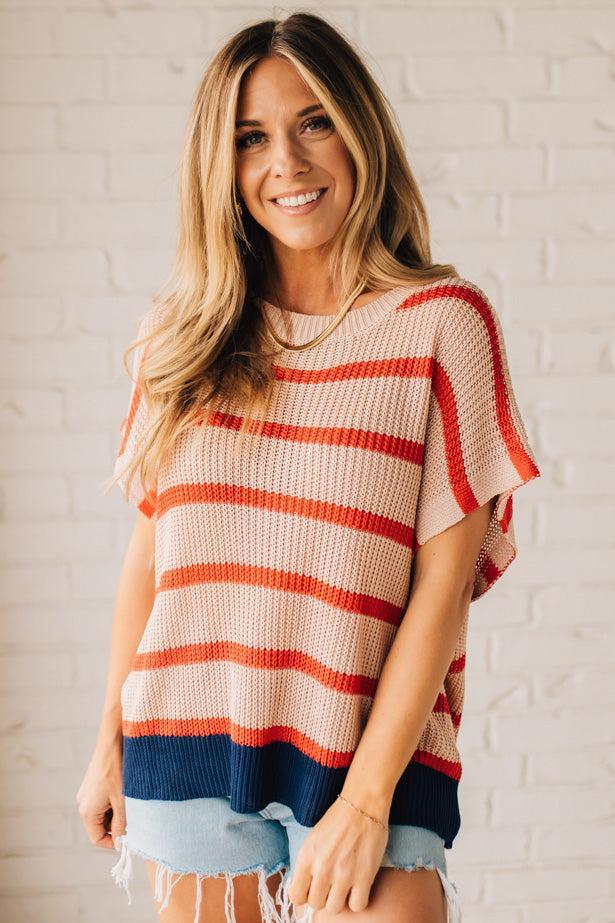 Blonde woman wearing a beige, red, and navy Stripe Drop Shoulder Sweater Top.