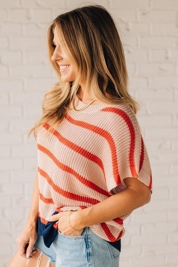 Blonde woman wearing a beige, red, and navy Stripe Drop Shoulder Sweater Top.