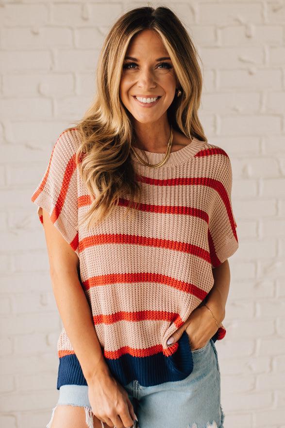 Blonde woman wearing a beige, red, and navy Stripe Drop Shoulder Sweater Top.