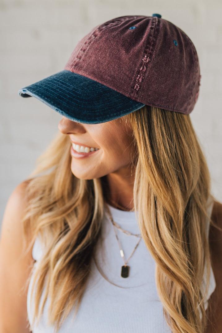 Blonde Woman Wearing a Burgundy and Navy Two-Toned Distressed Vintage Baseball Dad Hat.