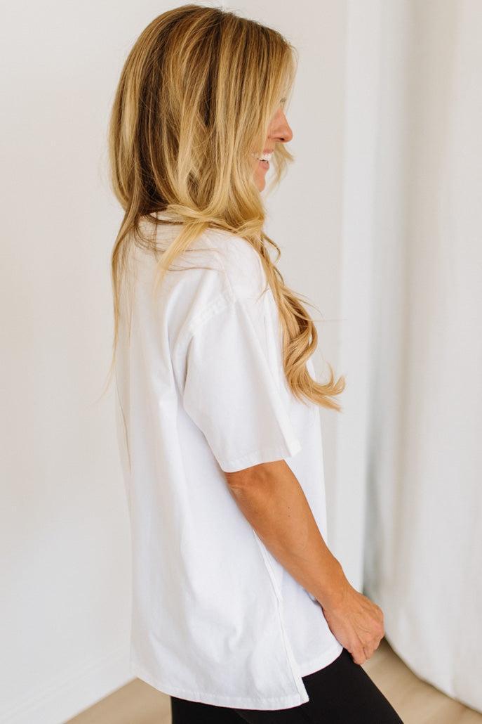 Woman wearing a white shirt against a plain background