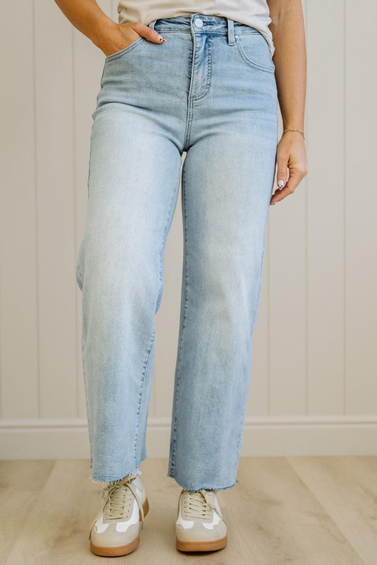 Light blue jeans worn by a person against a neutral background