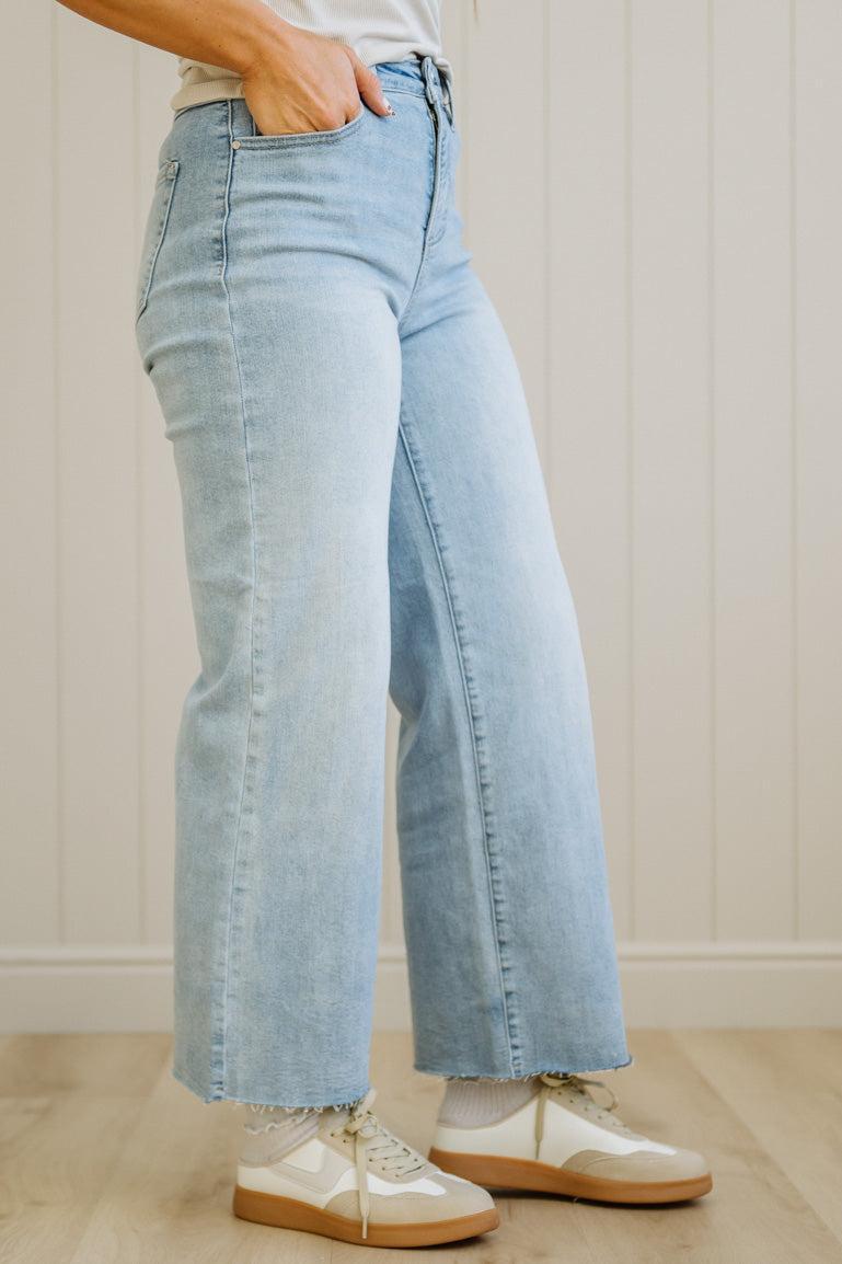 Light blue jeans worn by a person on a neutral background