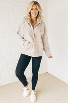 BLONDE WOMAN WEARING A SOLID COLOR ACID WASH FLEECE OVERSIZED 1/4 ZIP KANGAROO POCKET HOODIE.