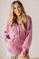 BLONDE WOMAN WEARING A SOLID COLOR ACID WASH FLEECE OVERSIZED 1/4 ZIP KANGAROO POCKET HOODIE.