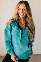 BLONDE WOMAN WEARING A SOLID COLOR ACID WASH FLEECE OVERSIZED 1/4 ZIP KANGAROO POCKET HOODIE.
