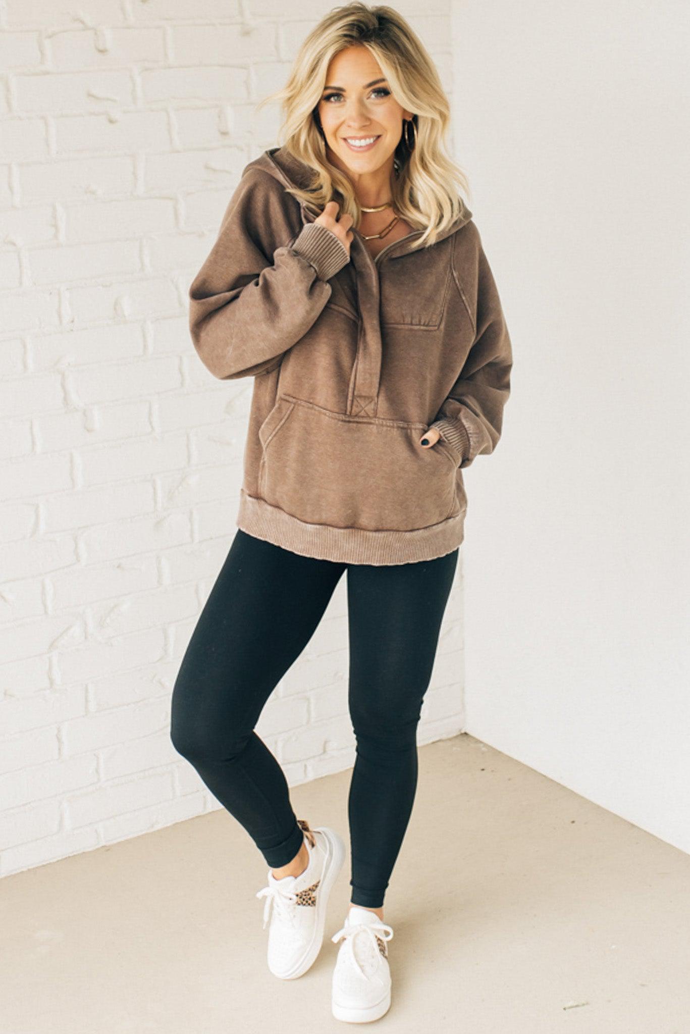BLONDE WOMAN WEARING A SOLID COLOR ACID WASH FLEECE OVERSIZED 1/4 ZIP KANGAROO POCKET HOODIE.