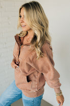 BLONDE WOMAN WEARING A SOLID COLOR ACID WASH FLEECE OVERSIZED 1/4 ZIP KANGAROO POCKET HOODIE.