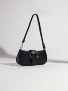 Small black handbag with large silver buckle accent and silver hardware