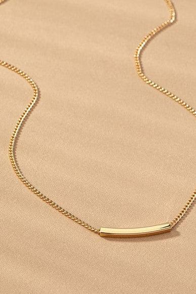 Gold necklace on a beige background