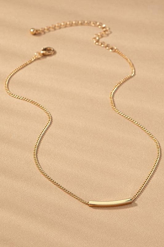 Gold necklace on a beige background