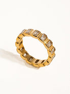 Gold ring with cubic zirconia baguettes all the way around.