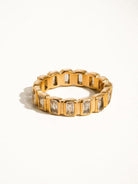 Gold ring with cubic zirconia baguettes all the way around.