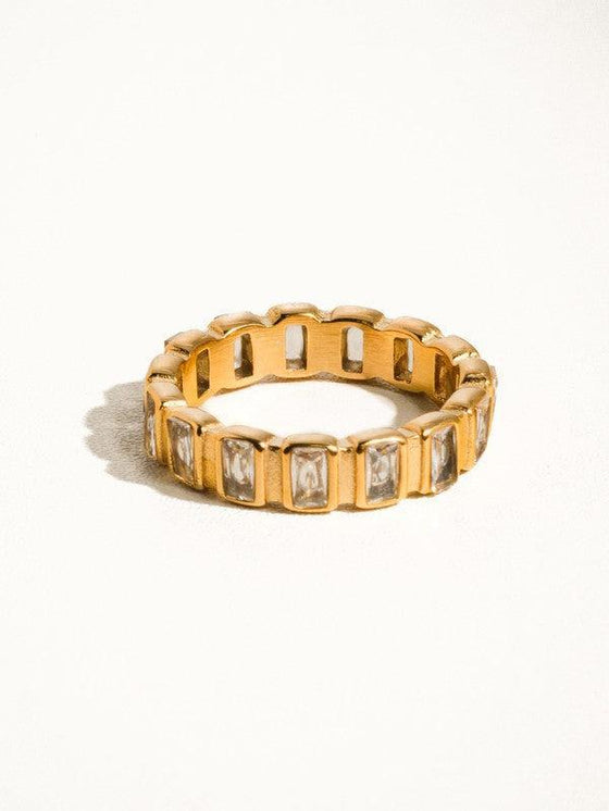 Gold ring with cubic zirconia baguettes all the way around.