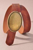 Close up image of a woman in blue jeans and patterned sweater featuring a Western Oval Buckle Leather Belt.