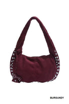 Burgundy handbag with studded details on a white background