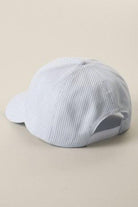 Light blue cap with a mesh back on a beige background