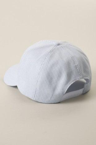 Light blue cap with a mesh back on a beige background
