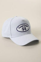 White cap with a logo on a beige background