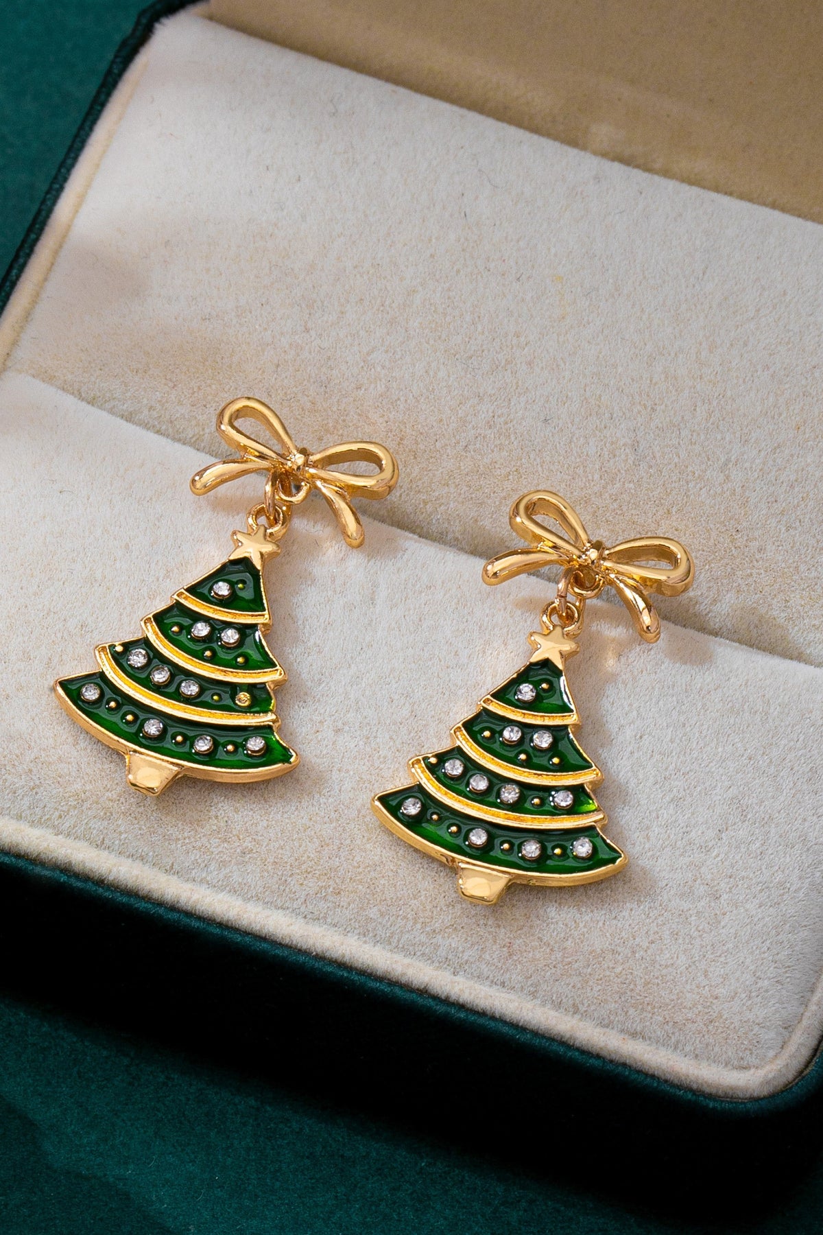 Festive Christmas Tree Motif: Designed with a tiered evergreen Christmas tree charm topped with a star detail hanging from a bow post back earring.