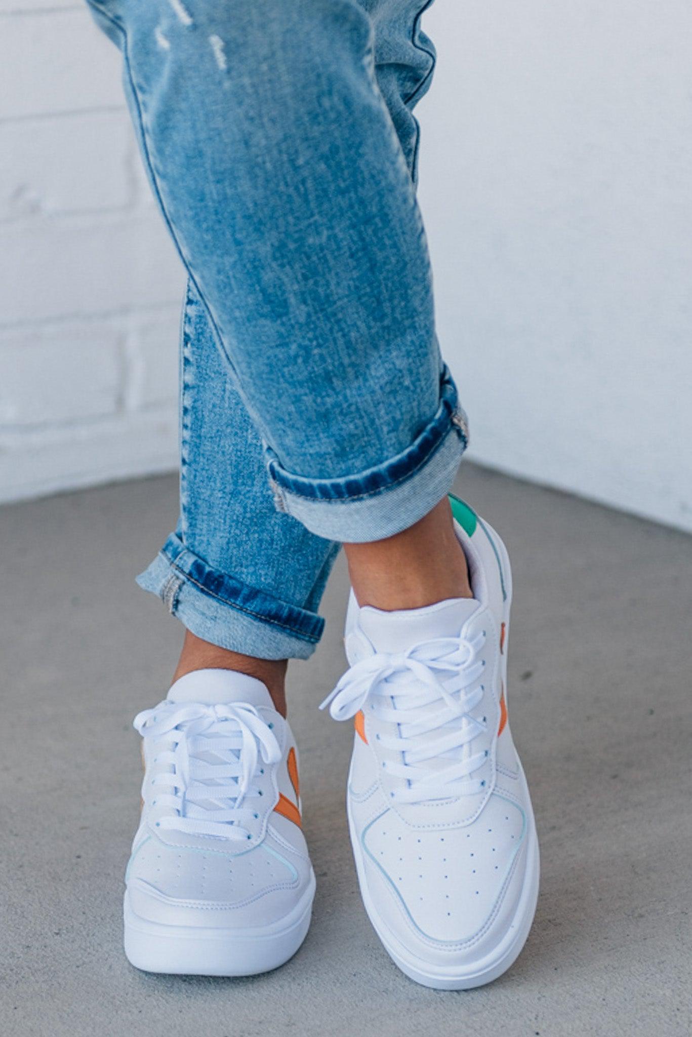 women's white sneakers with an orange and green accent