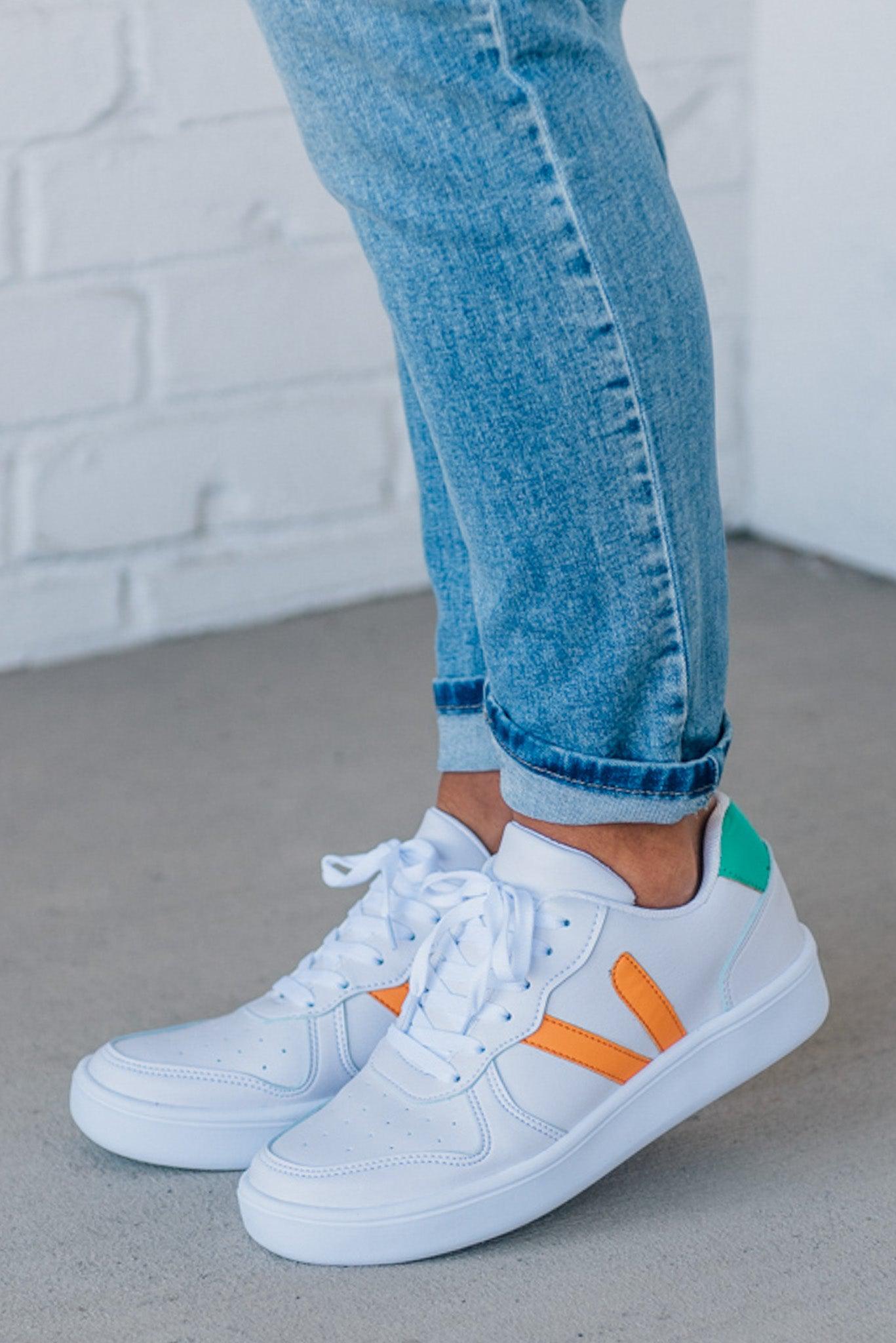 women's white sneakers with an orange and green accent