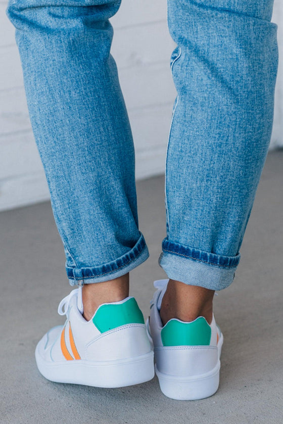 women's white sneakers with an orange and green accent