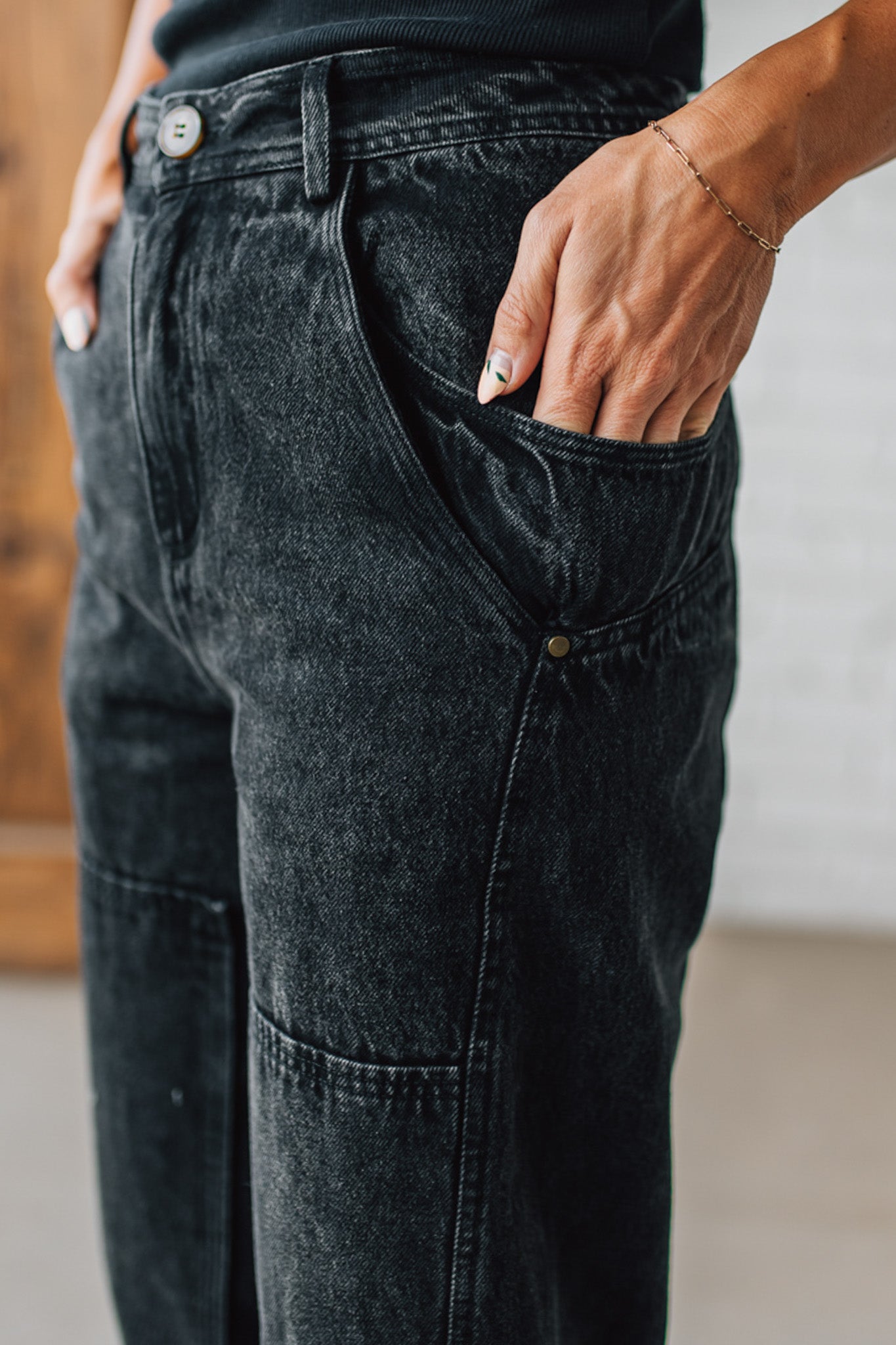 Person wearing black jeans with a blurred background