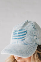 Blonde woman wearing a US Flag Monochomatic Embossed Baseball Ball Cap.