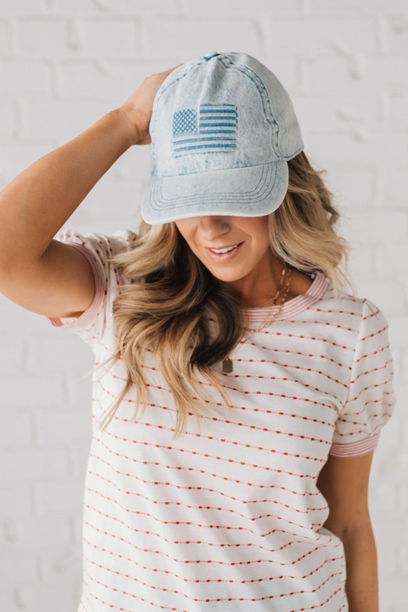 Blonde woman wearing a US Flag Monochomatic Embossed Baseball Ball Cap.