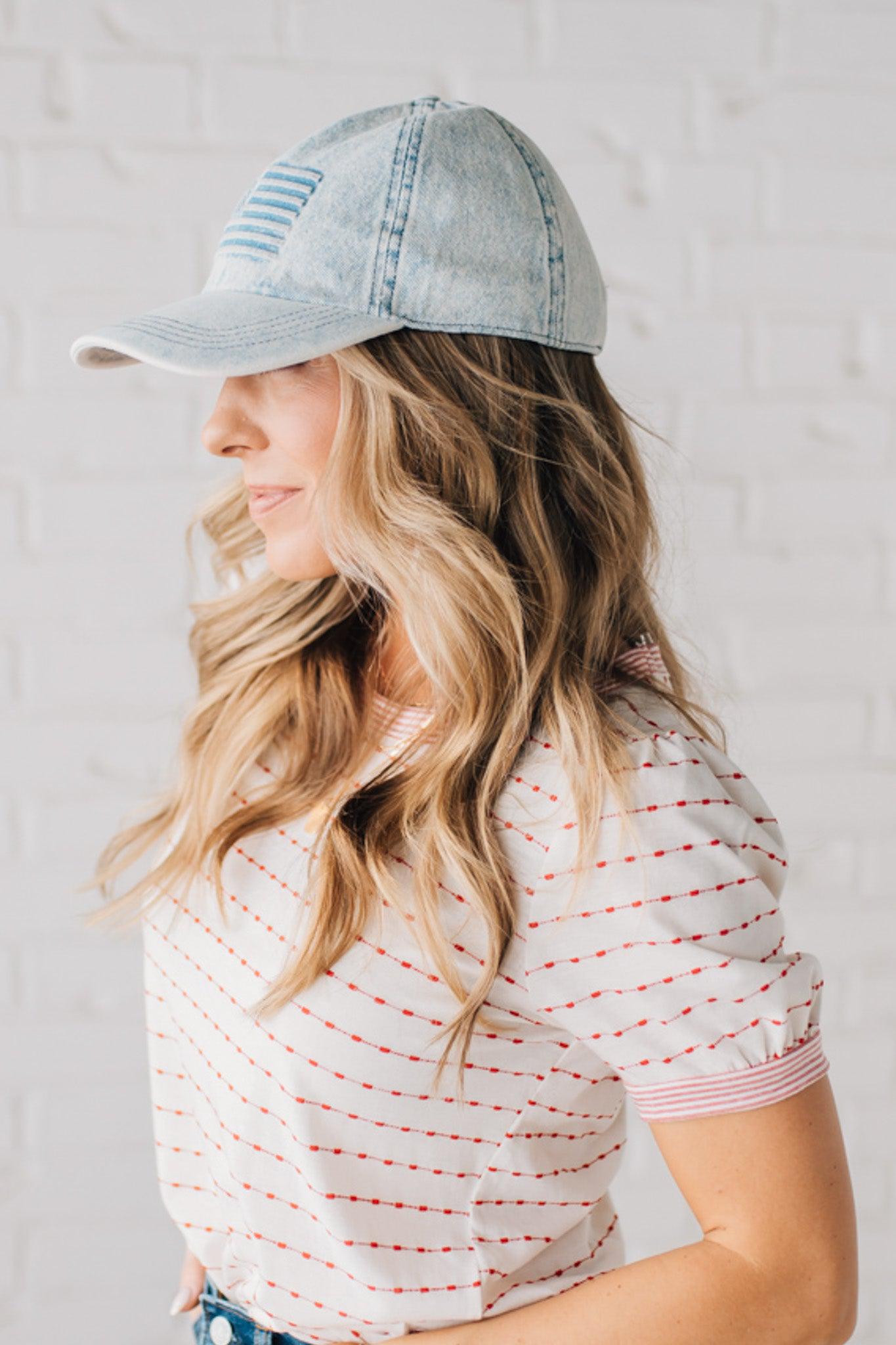 Blonde woman wearing a US Flag Monochomatic Embossed Baseball Ball Cap.