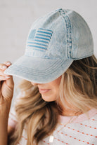 Blonde woman wearing a US Flag Monochomatic Embossed Baseball Ball Cap.