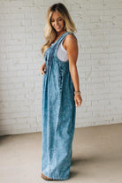 Blonde Woman Wearing a Mineral Washed Pintuck Jumpsuit With Side Pockets.