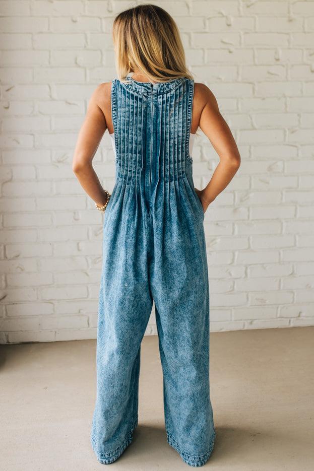Blonde Woman Wearing a Mineral Washed Pintuck Jumpsuit With Side Pockets.