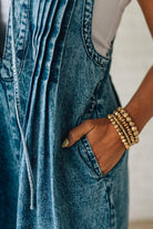 Blonde Woman Wearing a Mineral Washed Pintuck Jumpsuit With Side Pockets.