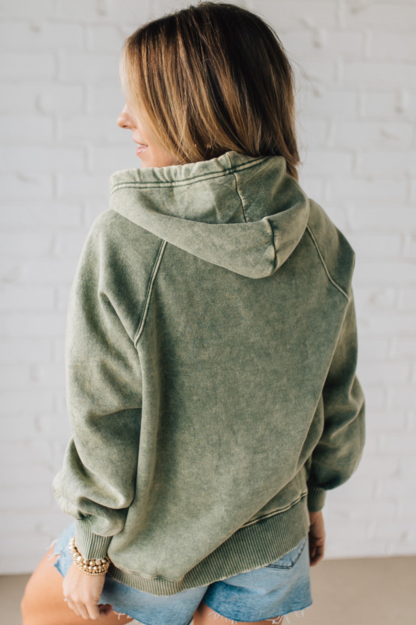 Blonde Woman Wearing a Solid Acid Wash Fleece Hoodie With Front Pocket