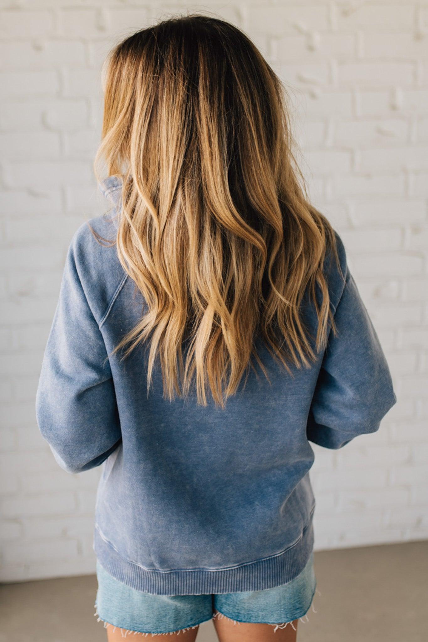 Blonde Woman Wearing a Solid Acid Wash Fleece Hoodie With Front Pocket