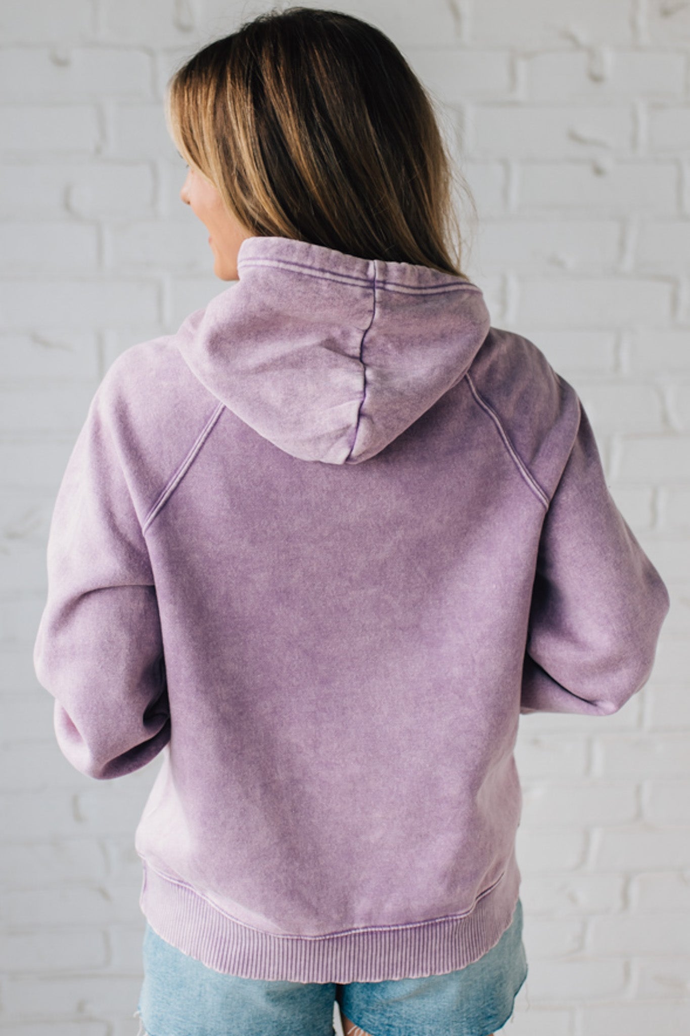 Blonde Woman Wearing a Solid Acid Wash Fleece Hoodie With Front Pocket