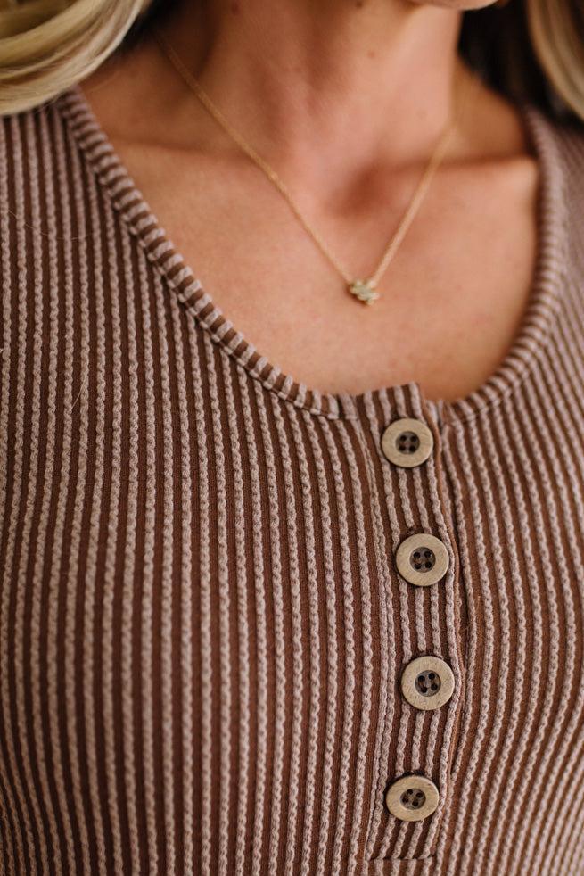 BLONDE WOMAN MODELING A RIBBED TANK DRESS WITH HENLEY STYLE WOOD BUTTONS AND TWO FRONT POCKETS