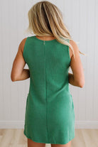 BLONDE WOMAN MODELING A RIBBED TANK DRESS WITH HENLEY STYLE WOOD BUTTONS AND TWO FRONT POCKETS