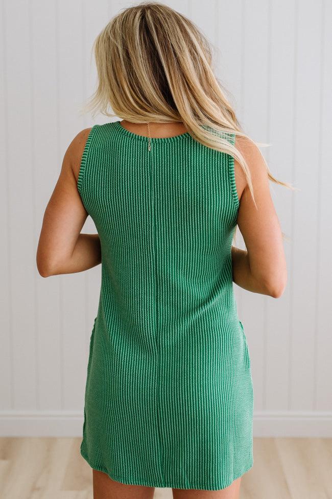 BLONDE WOMAN MODELING A RIBBED TANK DRESS WITH HENLEY STYLE WOOD BUTTONS AND TWO FRONT POCKETS