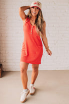 BLONDE WOMAN MODELING A RIBBED TANK DRESS WITH HENLEY STYLE WOOD BUTTONS AND TWO FRONT POCKETS