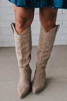 Knee Height light tan embroidered western style boots.